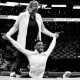 Biles stretching with a coach during an event at TD Garden in 2018.